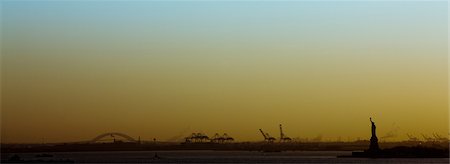 statue of liberty silhouette - USA, New York City, New York Harbor at sunset Stock Photo - Premium Royalty-Free, Code: 632-03779302