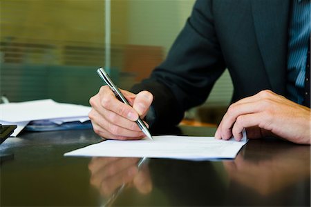 pen on desk - Executive signing paperwork, cropped Stock Photo - Premium Royalty-Free, Code: 632-03779558