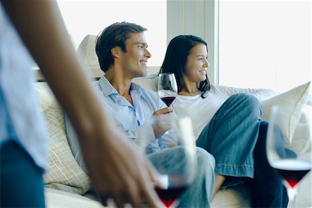 Couple enjoying red wine on sofa Stock Photo - Premium Royalty-Free, Code: 632-03779722