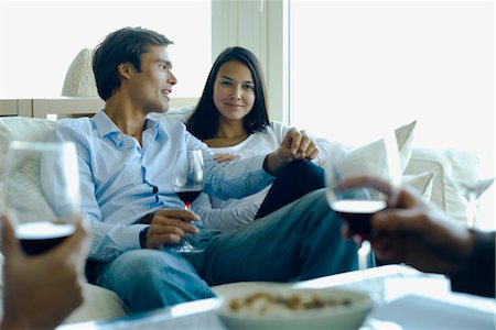 drinks in lounge - Couple enjoying red wine with friends Stock Photo - Premium Royalty-Free, Code: 632-03779766