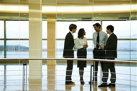 simsearch:632-03779792,k - Group of executives talking in corridor Stock Photo - Premium Royalty-Free, Code: 632-03779790