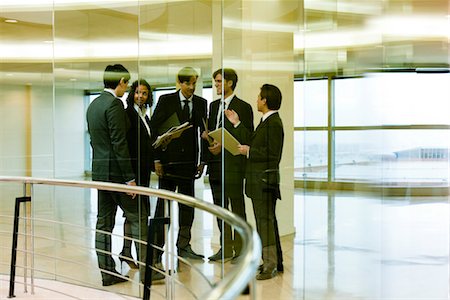 simsearch:632-03779792,k - Team of executives meeting in corridor Stock Photo - Premium Royalty-Free, Code: 632-03779826