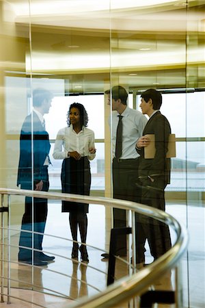 simsearch:632-03779792,k - Group of executives talking in corridor Stock Photo - Premium Royalty-Free, Code: 632-03779842