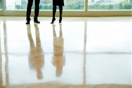 shiny - Businessman and businesswoman standing in lobby, low section Stock Photo - Premium Royalty-Free, Code: 632-03847711