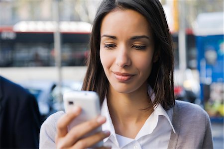 smartphone on the move - Woman text messaging outdoors Stock Photo - Premium Royalty-Free, Code: 632-03847721