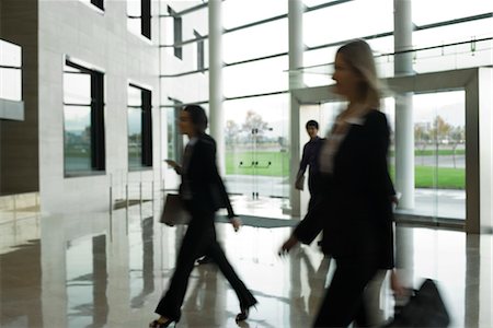 people walking into office building - Executives walking in lobby Stock Photo - Premium Royalty-Free, Code: 632-03847808