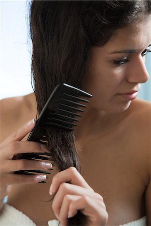 female hair care - Woman combing hair after a shower Stock Photo - Premium Royalty-Free, Code: 632-03847917