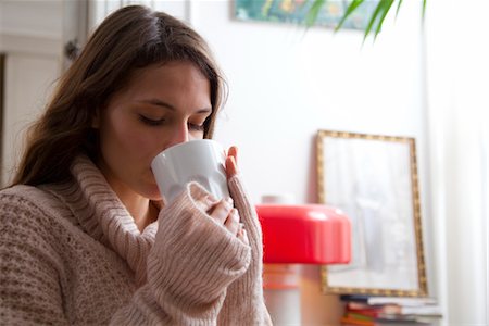 Young woman enjoying cup of coffee at home Stock Photo - Premium Royalty-Free, Code: 632-03847960