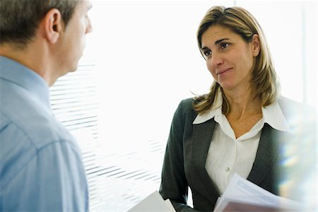 female executive headshot middle aged - Businesswoman talking to colleague Stock Photo - Premium Royalty-Free, Code: 632-03848032