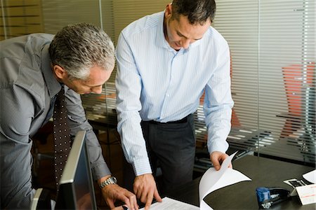 executives working together - Colleagues discussing document in office Stock Photo - Premium Royalty-Free, Code: 632-03848078