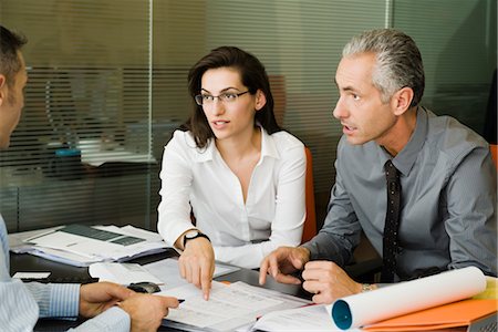 Clients discussing paperwork with businessman Stock Photo - Premium Royalty-Free, Code: 632-03848084