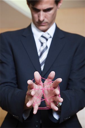 simsearch:632-06118662,k - Businessman playing cat's cradle with string Stock Photo - Premium Royalty-Free, Code: 632-03848104