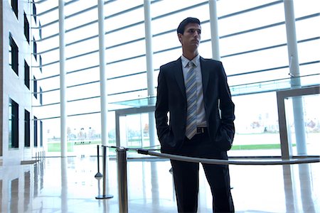 Businessman standing in lobby Stock Photo - Premium Royalty-Free, Code: 632-03848127