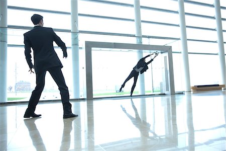 Businessmen playing soccer in lobby Stock Photo - Premium Royalty-Free, Code: 632-03848121