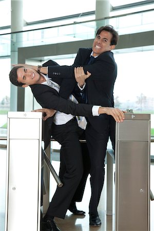 simsearch:632-05816903,k - Businessmen fighting to beat each other through turnstile Stock Photo - Premium Royalty-Free, Code: 632-03848149