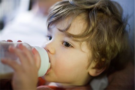 Toddler boy drinking milk from baby bottle Foto de stock - Sin royalties Premium, Código: 632-03848250