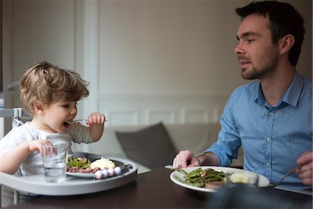 family eating dinner together - Father and toddler son eating dinner together Stock Photo - Premium Royalty-Free, Code: 632-03848280