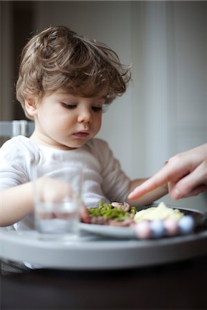 refuse - Toddler boy being told to eat his vegetables, cropped Stock Photo - Premium Royalty-Free, Code: 632-03848305