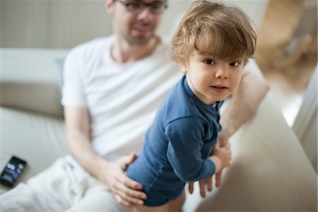 simsearch:632-03848420,k - Toddler boy on couch with father, looking at camera Stock Photo - Premium Royalty-Free, Code: 632-03848374