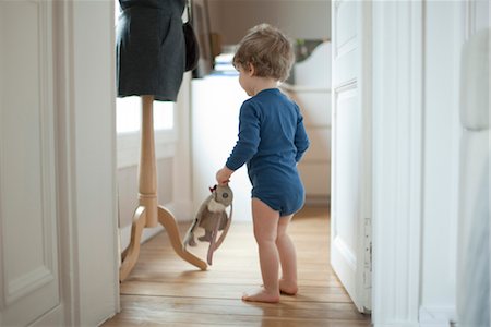 people with stuffed animals - Toddler boy holding toy at home, rear view Stock Photo - Premium Royalty-Free, Code: 632-03848378