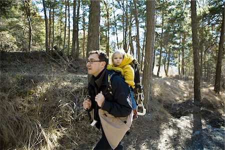 family hike - Father hiking in woods with baby daughter in backpack carrier Stock Photo - Premium Royalty-Free, Code: 632-03897875