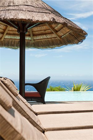 deck chair swimming pool nobody - Poolside lounge chairs at seaside resort Stock Photo - Premium Royalty-Free, Code: 632-03897982