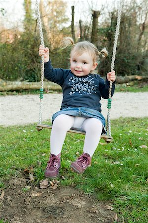 Toddler girl on swing, portrait Stock Photo - Premium Royalty-Free, Code: 632-03898070