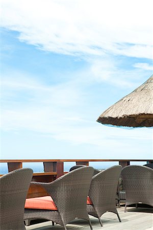 deck chair railing - Wicker chairs lined up along deck Stock Photo - Premium Royalty-Free, Code: 632-03898086