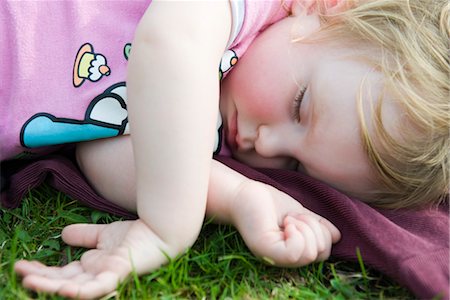 Toddler girl taking a nap outdoors Stock Photo - Premium Royalty-Free, Code: 632-03898100
