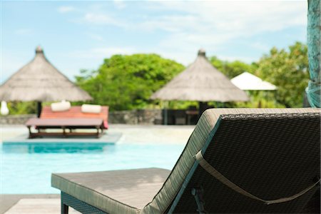 Lounge chair beside pool at resort Stock Photo - Premium Royalty-Free, Code: 632-03898134