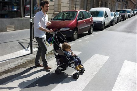 street man car - Father pushing toddler son in stroller Stock Photo - Premium Royalty-Free, Code: 632-03898226