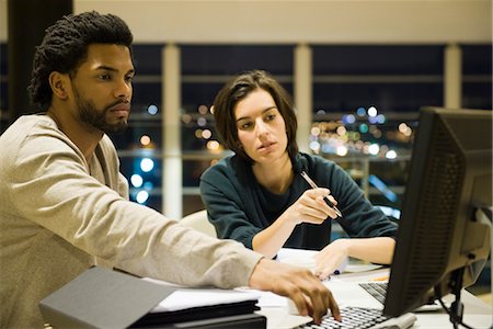 Collègues qui travaillent sur le projet ensemble dans le bureau pendant la nuit Photographie de stock - Premium Libres de Droits, Code: 632-03898360