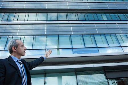 simsearch:649-05657045,k - Executive gesturing at office building Stock Photo - Premium Royalty-Free, Code: 632-03898467