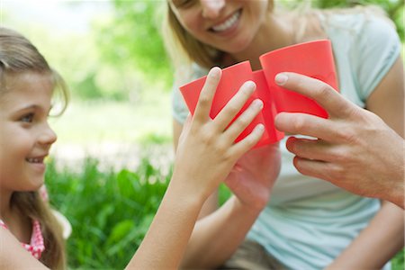 simsearch:633-05401448,k - Family clinking glasses at outdoor picnic, cropped Stock Photo - Premium Royalty-Free, Code: 633-05401394