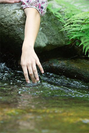 sensation - Young woman's hand touching water in stream Stock Photo - Premium Royalty-Free, Code: 633-05401441