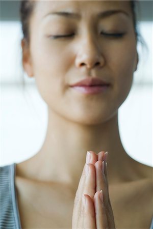 simsearch:633-05401584,k - Young woman meditating in prayer position Stock Photo - Premium Royalty-Free, Code: 633-05401491