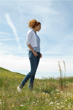 Young woman walking in meadow Stock Photo - Premium Royalty-Free, Code: 633-05401506