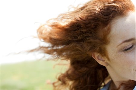 simsearch:633-05402126,k - Redheaded woman with hair blowing in wind Stock Photo - Premium Royalty-Free, Code: 633-05401500