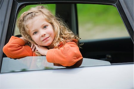 Little girl leaning out car window, portrait Stock Photo - Premium Royalty-Free, Code: 633-05401535