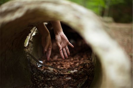 secret - Hands, seeing through concrete pipe Stock Photo - Premium Royalty-Free, Code: 633-05401551