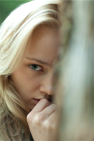 scared person - Young woman with serious expression, cropped Stock Photo - Premium Royalty-Free, Code: 633-05401552