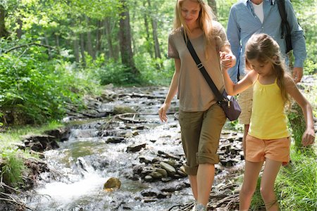 Family walking beside stream in woods Stock Photo - Premium Royalty-Free, Code: 633-05401662