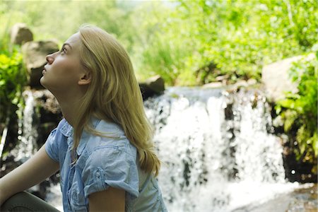 simsearch:633-05401566,k - Young woman sitting by waterfall Stock Photo - Premium Royalty-Free, Code: 633-05401719