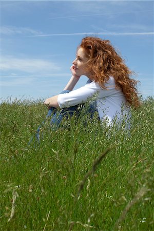 sitting on the ground - Woman daydreaming in meadow Stock Photo - Premium Royalty-Free, Code: 633-05401746