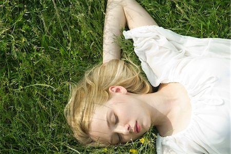 simsearch:632-05604058,k - Young woman napping on grass Stock Photo - Premium Royalty-Free, Code: 633-05401760