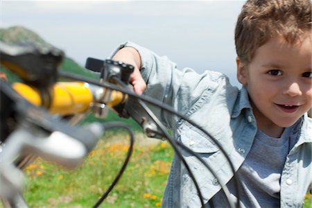 Boy riding bicycle, portrait Stock Photo - Premium Royalty-Free, Code: 633-05401784