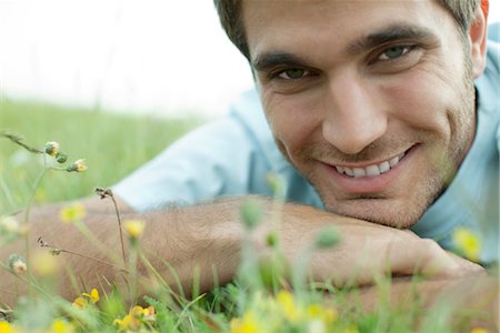 dimpled - Man relaxing on meadow, cropped Stock Photo - Premium Royalty-Free, Code: 633-05401794