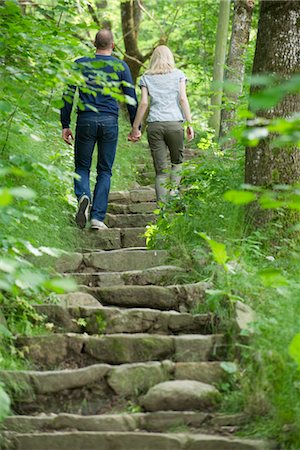 people on stairs - Couple walking up stone steps in woods Stock Photo - Premium Royalty-Free, Code: 633-05401799