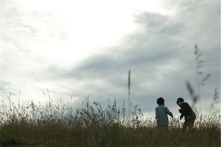 playing human grass - Boys playing on meadow, rear view Stock Photo - Premium Royalty-Free, Code: 633-05401917