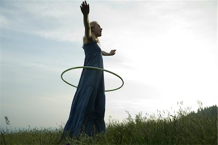 simsearch:633-05402126,k - Young woman playing with plastic hoop outdoors Stock Photo - Premium Royalty-Free, Code: 633-05402016